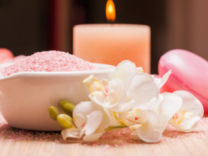Setting the mood with candles and flowers for geriatric massage therapy.