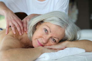 Older woman receiving geriatric massage therapy.