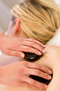 Woman receiving a hot stone massage.
